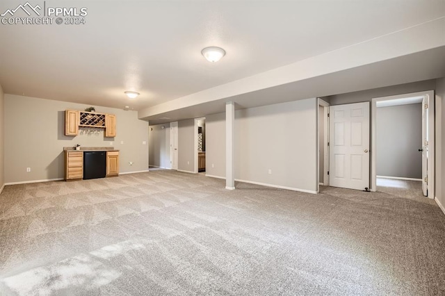 basement featuring light carpet and indoor bar