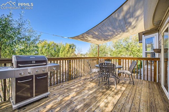 wooden terrace featuring area for grilling