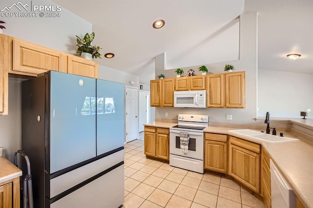 kitchen with light brown cabinets, sink, vaulted ceiling, and white appliances