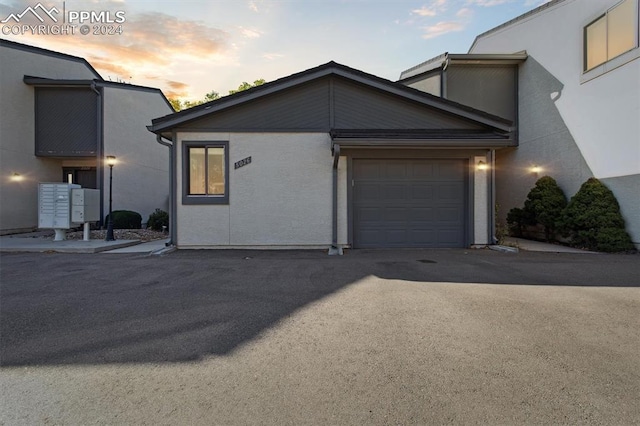 property exterior at dusk featuring a garage