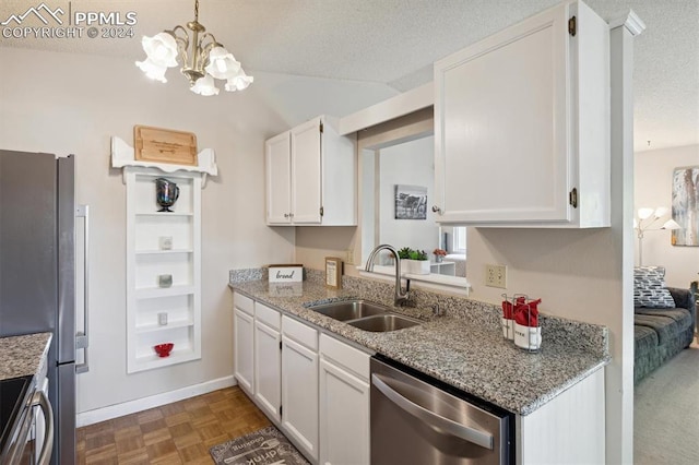 kitchen featuring white cabinetry, stainless steel appliances, sink, and a textured ceiling