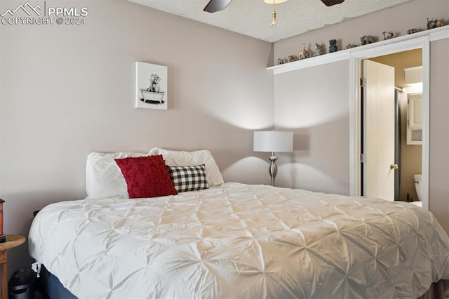 bedroom with a textured ceiling and ceiling fan