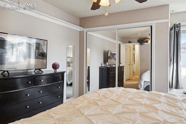 bedroom with a closet, ceiling fan, and a textured ceiling