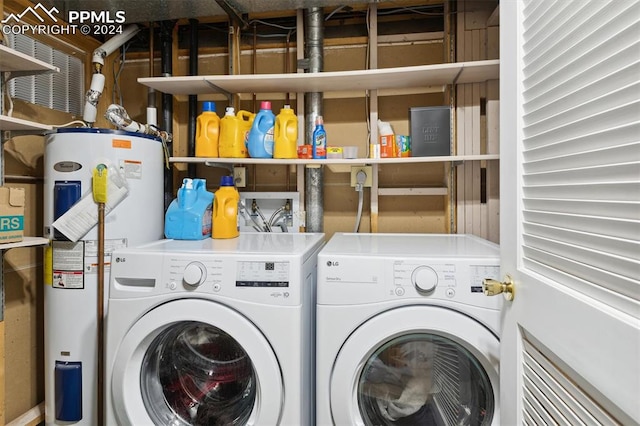 laundry area with water heater and separate washer and dryer