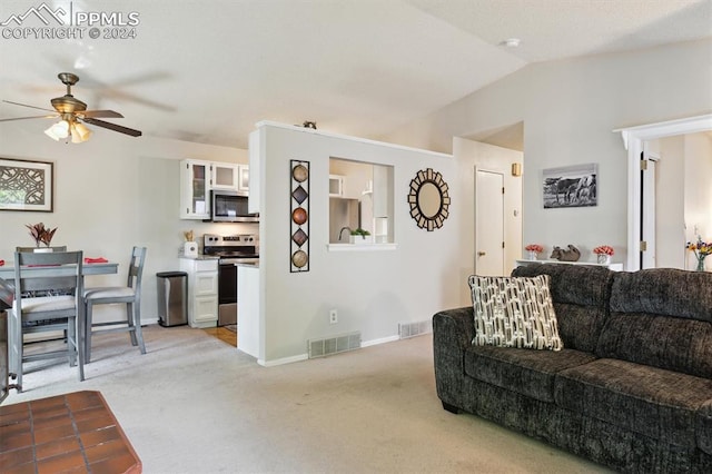 living room with ceiling fan, lofted ceiling, and light colored carpet