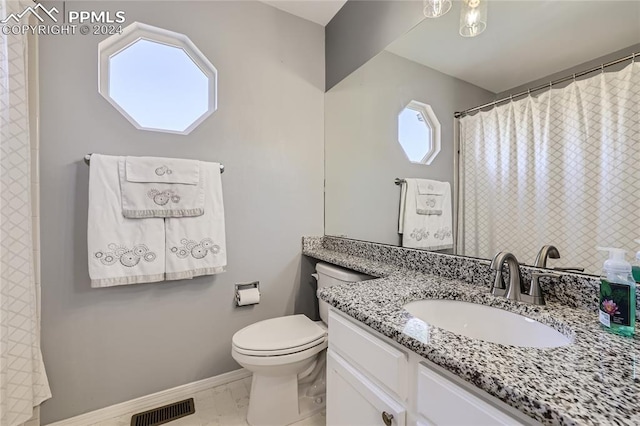 bathroom with toilet and vanity