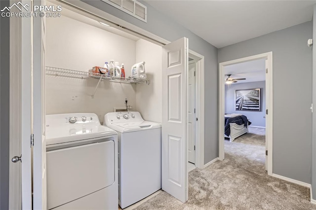 laundry room featuring independent washer and dryer, light carpet, and ceiling fan