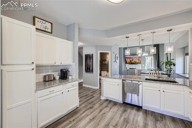 kitchen with light stone countertops, light wood-type flooring, decorative light fixtures, stainless steel dishwasher, and white cabinets