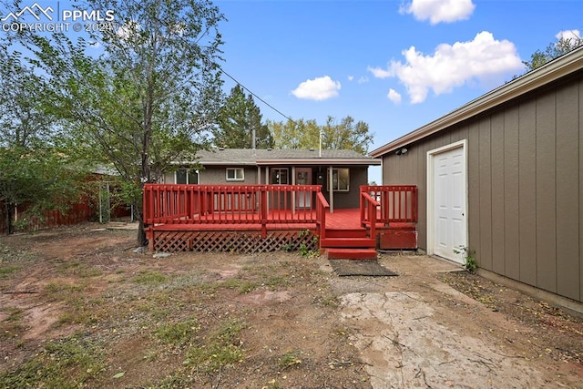 rear view of property featuring a deck