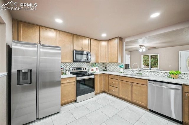 kitchen featuring decorative backsplash, ceiling fan, appliances with stainless steel finishes, light tile patterned flooring, and sink