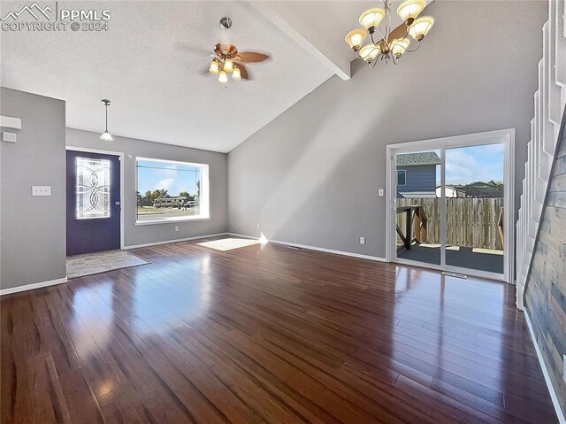 unfurnished living room with ceiling fan with notable chandelier, a textured ceiling, dark hardwood / wood-style flooring, beamed ceiling, and high vaulted ceiling