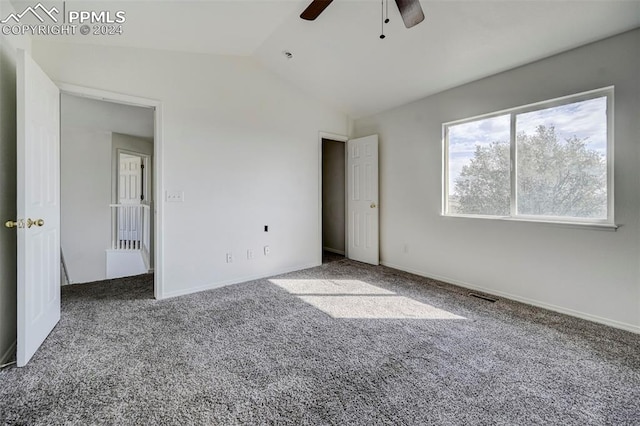 unfurnished bedroom featuring ceiling fan, carpet, and lofted ceiling