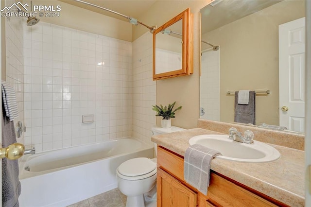 full bathroom with toilet, vanity, tile patterned floors, and tiled shower / bath