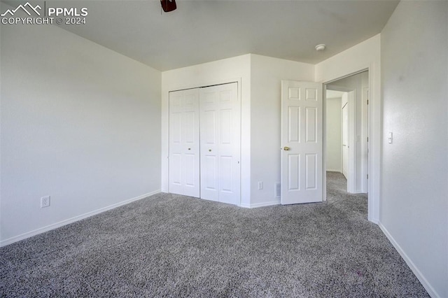 unfurnished bedroom with carpet flooring, ceiling fan, and a closet