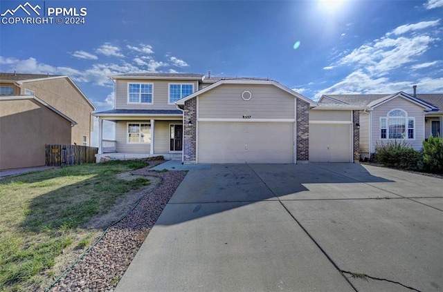 view of front of property with covered porch and a garage