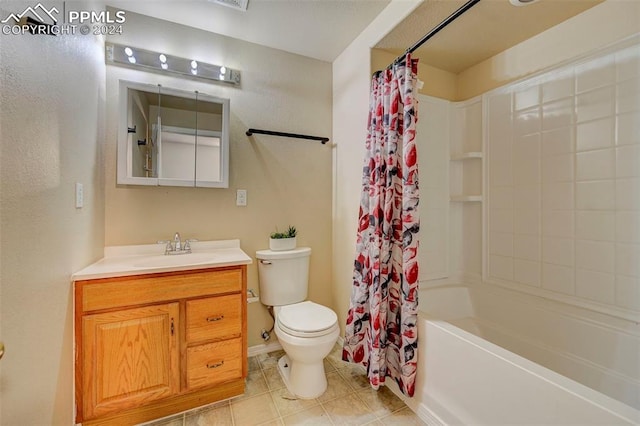 full bathroom with tile patterned floors, vanity, toilet, and shower / bath combo with shower curtain