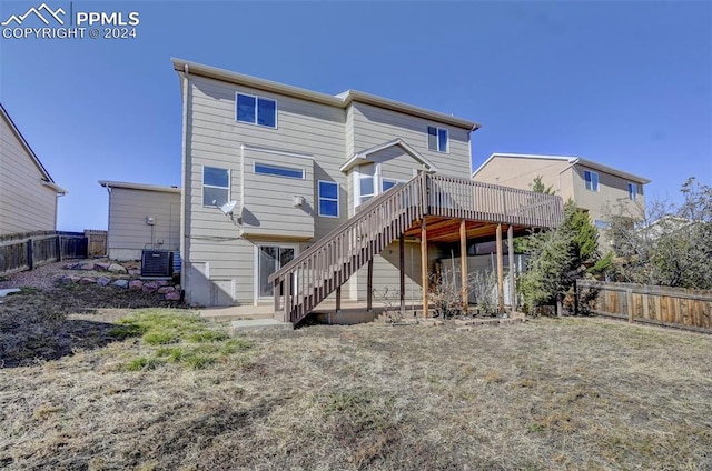 rear view of house featuring a wooden deck