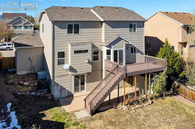 rear view of house featuring a wooden deck