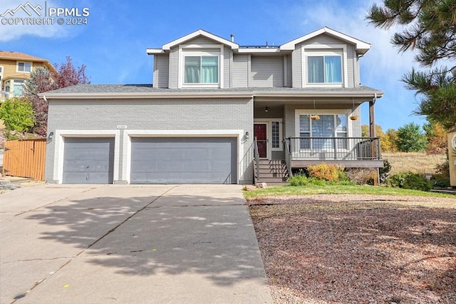 view of front of home with a porch and a garage