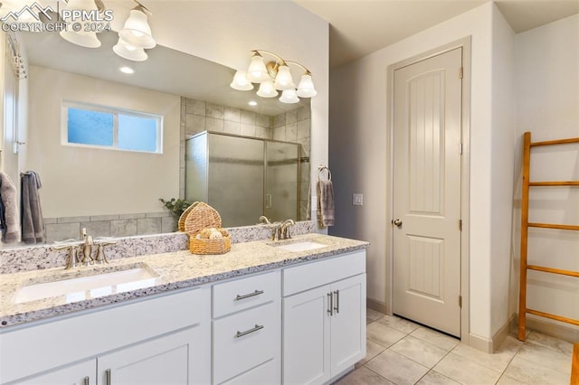 bathroom featuring vanity, a shower with shower door, and tile patterned flooring