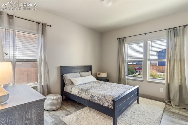 bedroom with hardwood / wood-style flooring