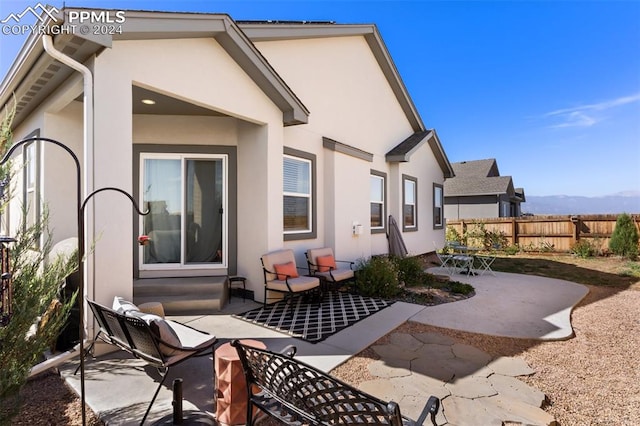 rear view of house featuring an outdoor hangout area, a mountain view, and a patio area