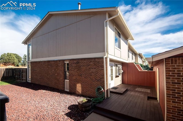 view of home's exterior with a wooden deck