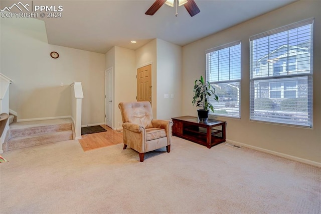 sitting room featuring light carpet and ceiling fan