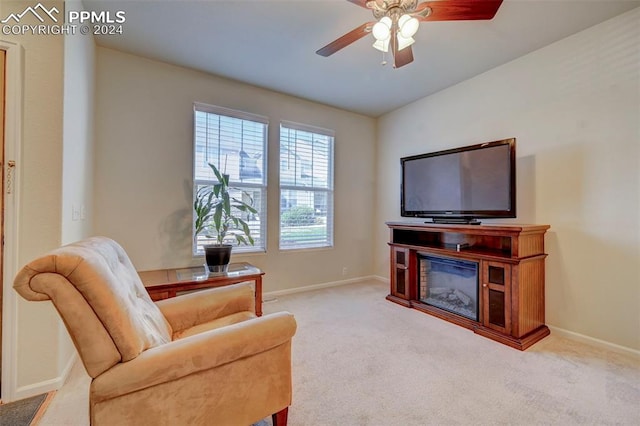 living room with ceiling fan and light colored carpet