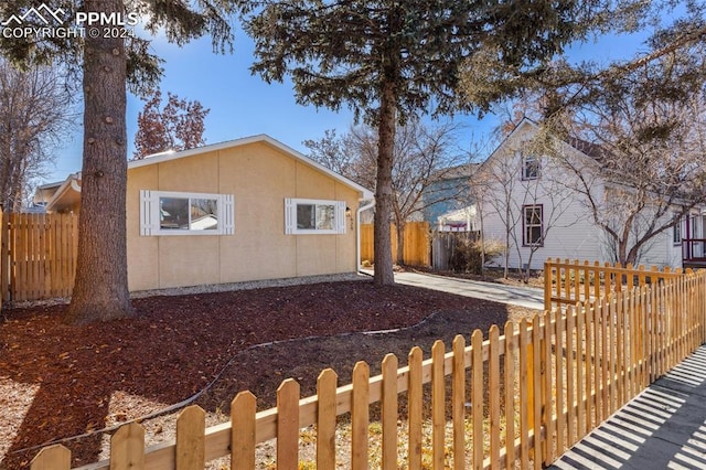 view of property exterior with fence