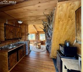 kitchen featuring wood-type flooring and wood walls