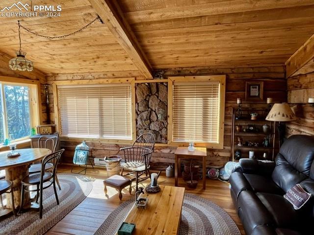 living room with hardwood / wood-style floors, wooden ceiling, and vaulted ceiling