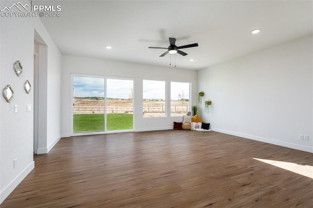 empty room featuring dark wood-type flooring and ceiling fan