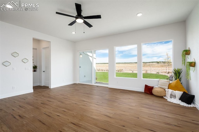 interior space with hardwood / wood-style floors and ceiling fan