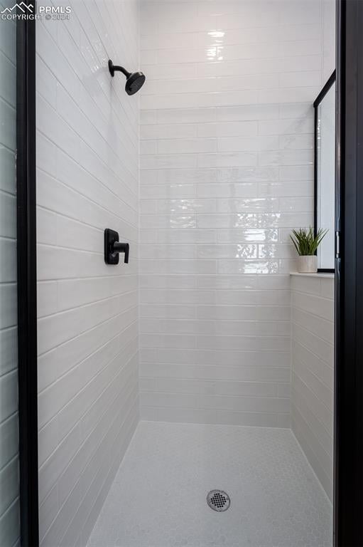 bathroom with a tile shower