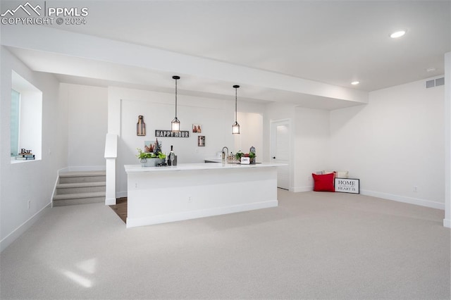 bar featuring carpet floors and pendant lighting