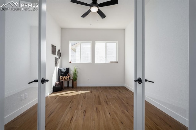 workout room featuring french doors, ceiling fan, and wood-type flooring