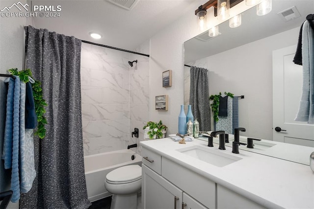 full bathroom with vanity, shower / tub combo, and toilet