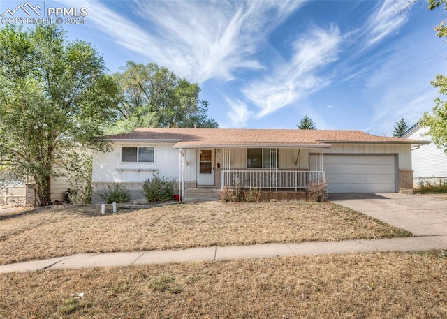 ranch-style house featuring a garage and a porch