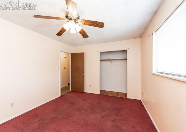 unfurnished bedroom with carpet, a closet, and ceiling fan