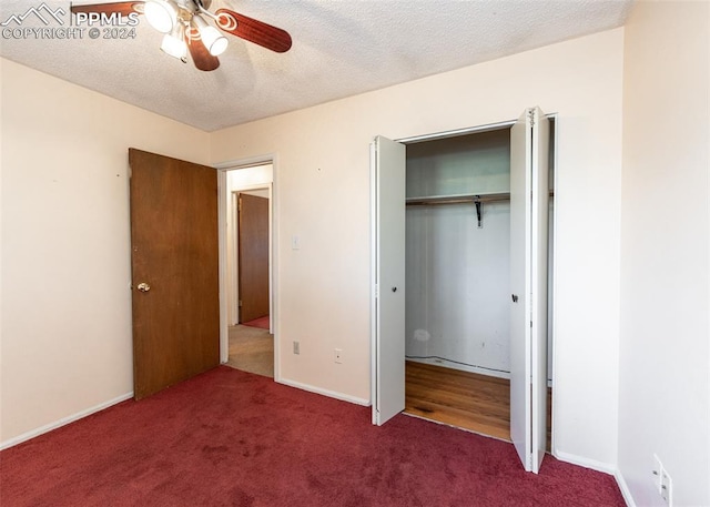 unfurnished bedroom featuring a textured ceiling, carpet flooring, a closet, and ceiling fan