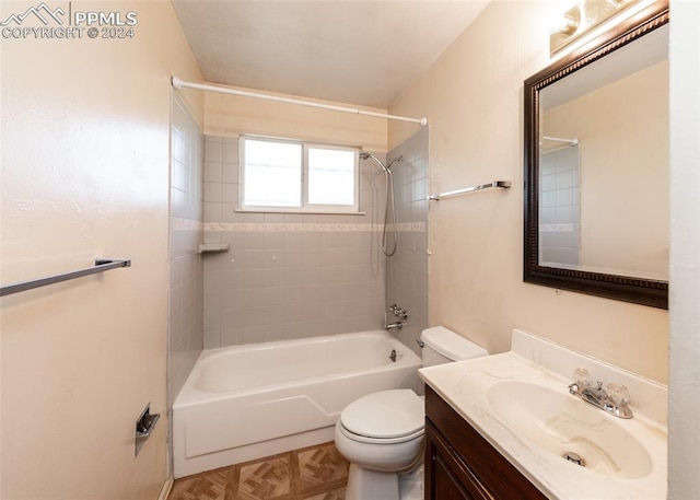 full bathroom featuring vanity, toilet, and tiled shower / bath combo