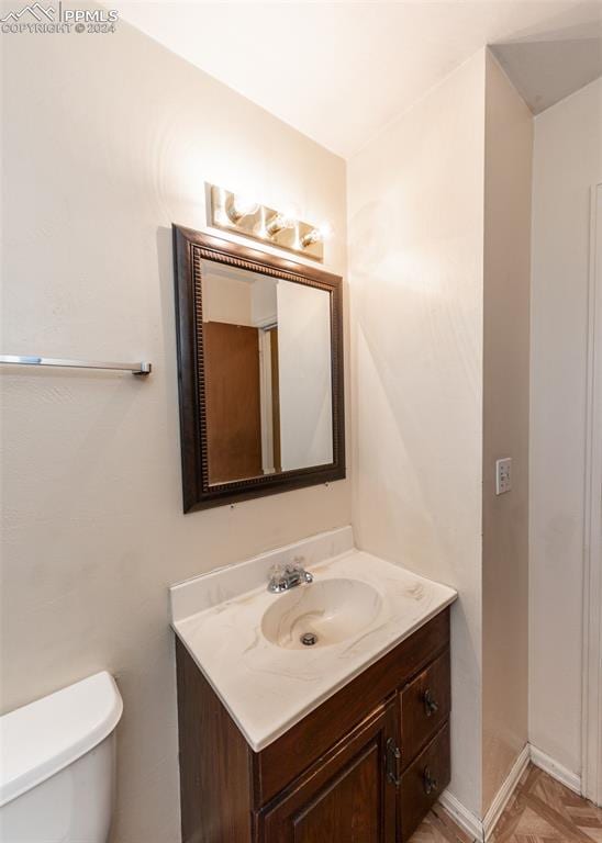 bathroom with toilet and vanity