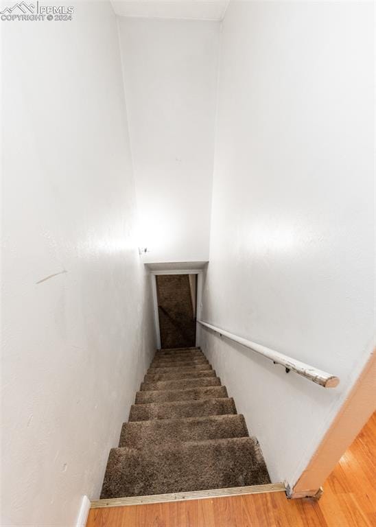 stairs featuring wood-type flooring