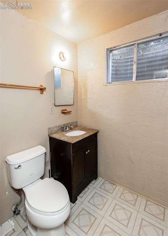 bathroom with vanity, toilet, and tile patterned flooring