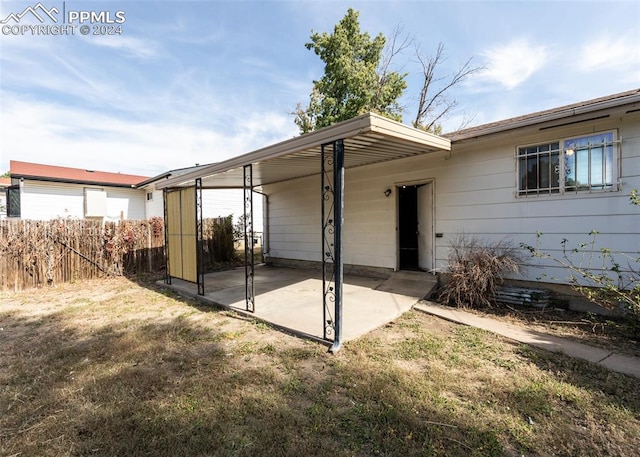 back of house with a yard and a patio area