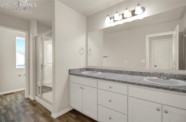 bathroom with vanity, hardwood / wood-style floors, and walk in shower