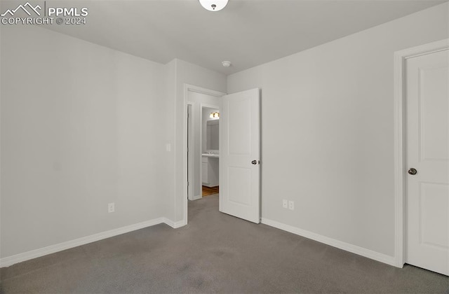 unfurnished bedroom featuring dark colored carpet