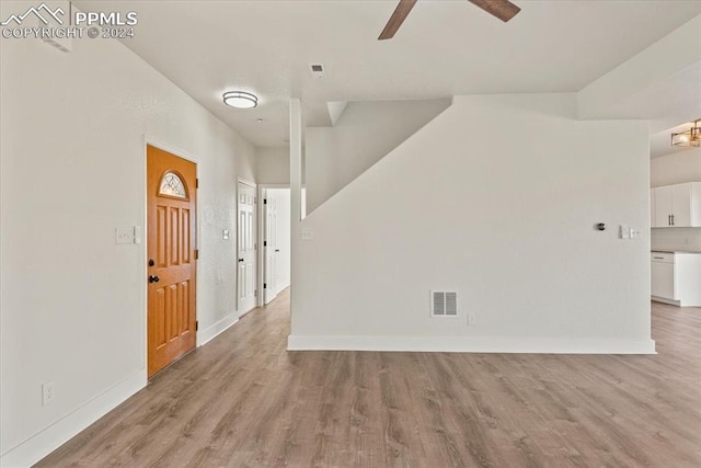 empty room with ceiling fan and light wood-type flooring