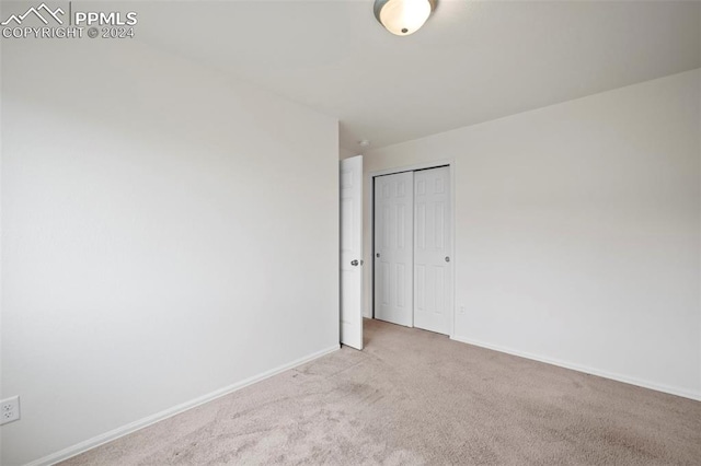 empty room featuring light carpet